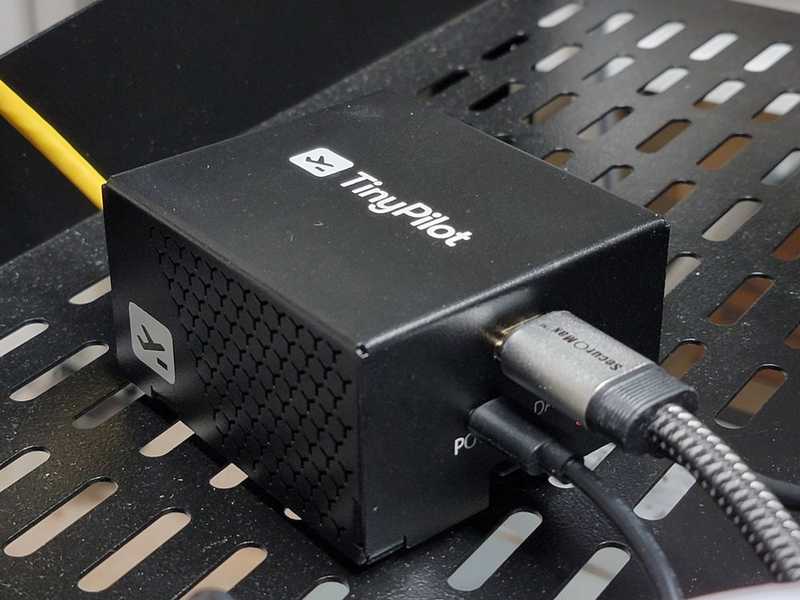 TinyPilot Voyager 2a device placed on top of a 1U server rack shelf