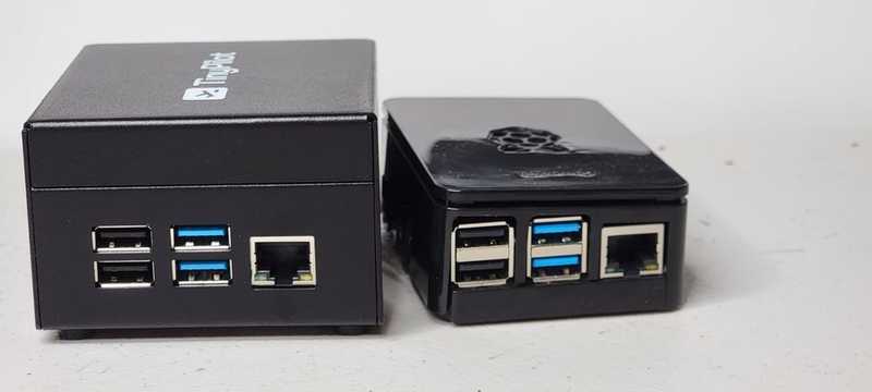 TinyPilot Voyager 2a and CanaKit devices side by side, IO ports facing camera